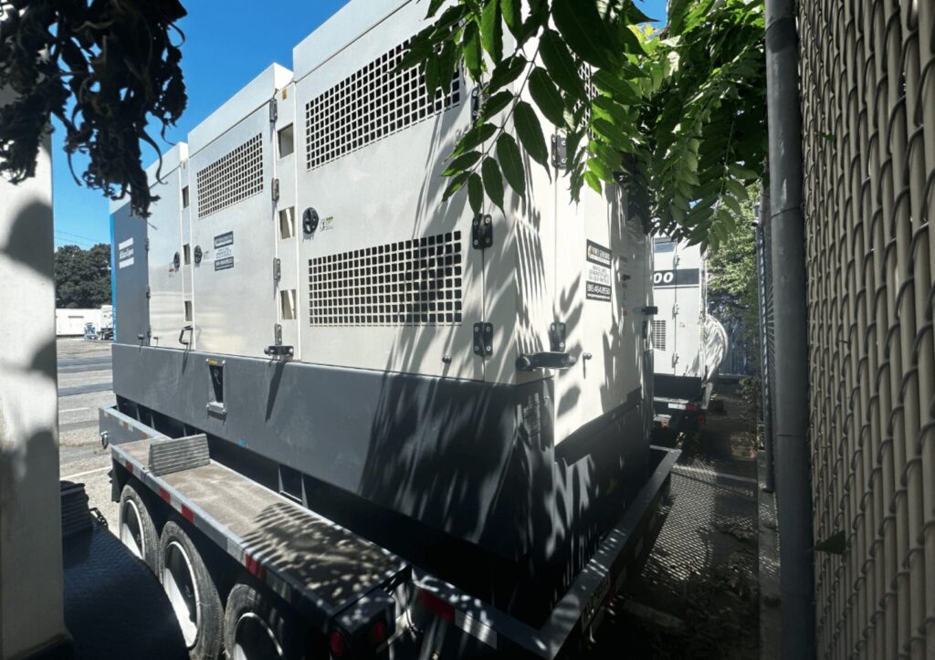 Front angle of Atlas Copco QAS700VD Trailer Mounted Diesel Generator mounted on trailer for emergency standby applications